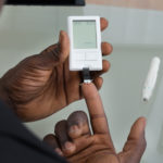 diabetic man doing finger test