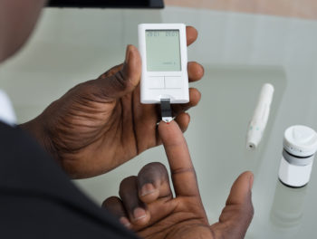 diabetic man doing finger test