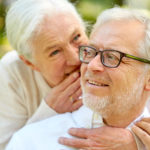 Woman whispers to mans ear