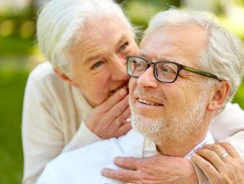 Woman whispers to mans ear