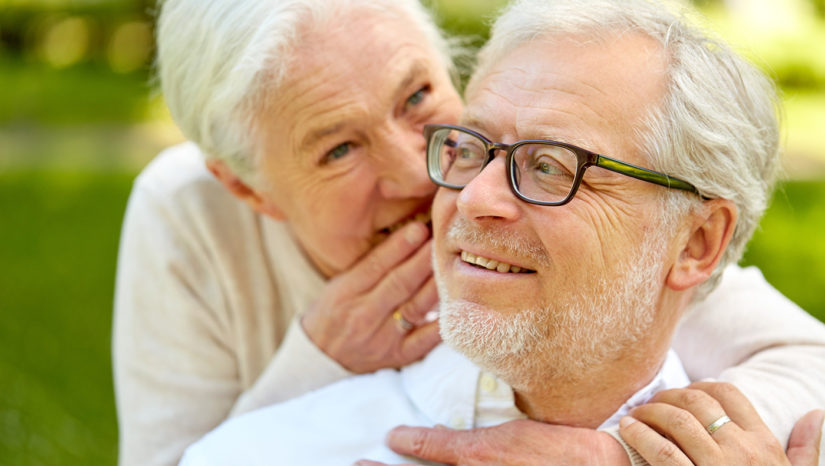Woman whispers to mans ear