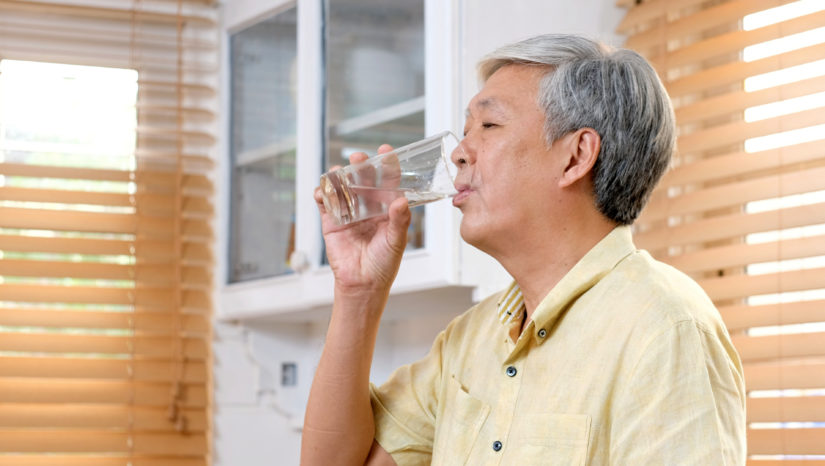 Senior man drinking a glass of water